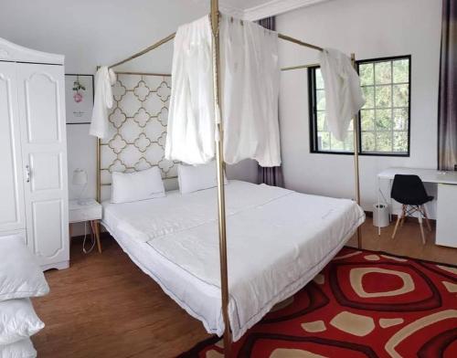 a bedroom with a canopy bed and a red rug at Summer Stay in Garapan