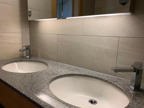 a bathroom with a sink and a mirror at Route de la Résidence in Villars-sur-Ollon