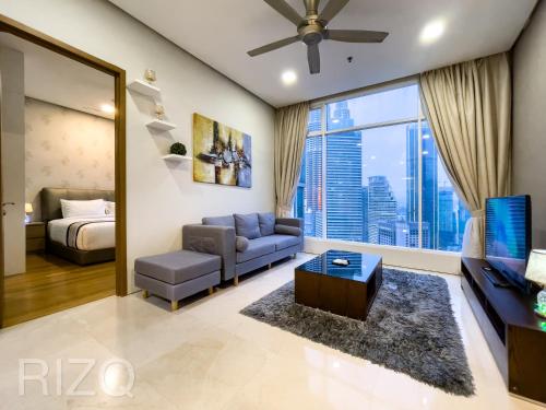 Soho suites klcc by Homestay في كوالالمبور: غرفة معيشة بها أريكة وسرير