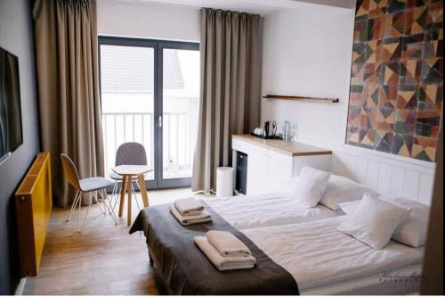 מיטה או מיטות בחדר ב-Na Fali Restaurant&Apartaments
