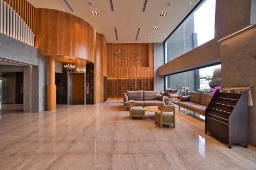 a lobby with couches and a piano at Taihe sun and the moon hostel in Yuchi