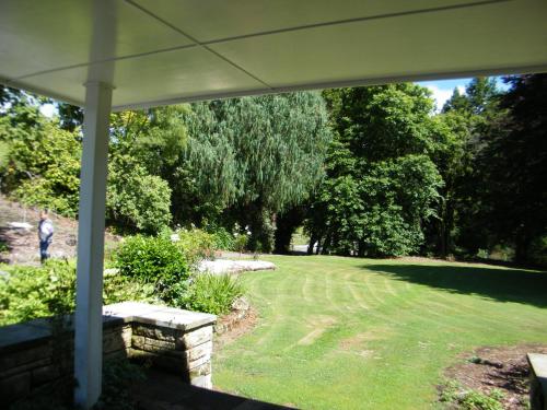 a view of a yard from the porch of a house at Timber Trail Farmstay in Ongarue