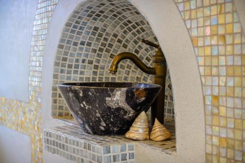 a sink in a bathroom with a faucet at The Flame Tree Estate & Hotel in Kandy