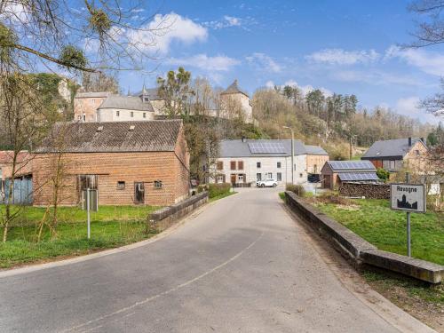an empty road in a village with buildings at Cozy Chalet with Garden in Beauraing