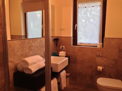 a bathroom with a sink and a toilet and a mirror at Charming Bellagio Boutique Hotel in Bellagio