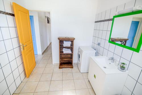 a bathroom with a sink and a toilet and a mirror at BED AND COFFEE PLAGE in La Trinité