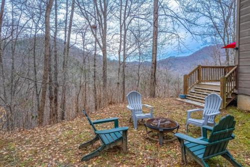 a group of chairs and a table on a porch at Tree Top Cabin in Sylva