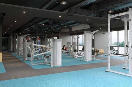 a gym with several treadmills and machines at Self-check-in private studio apartment in Phnom Penh