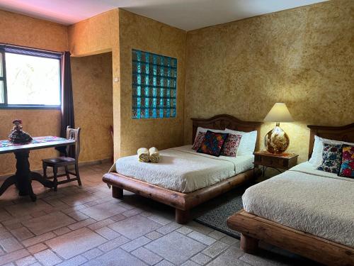 Postel nebo postele na pokoji v ubytování Hacienda Boutique B&B and Spa Solo Adultos