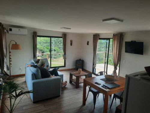 a person sitting on a couch in a living room at casas kiran y kanu in Villa Serrana