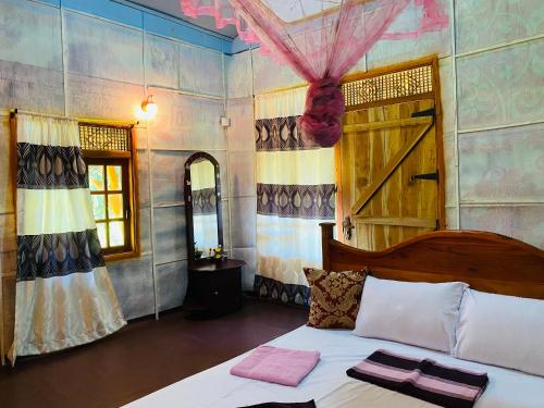 a bedroom with a bed with two towels on it at Sigiri Lion Eco Palace in Sigiriya