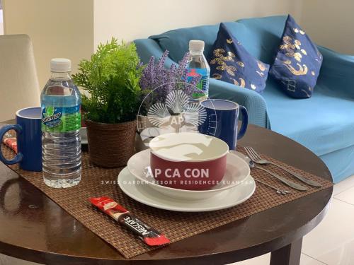 a coffee table with a cup of coffee and water at SG Resort Residences Kuantan by AP CA CON in Kampung Sungai Karang