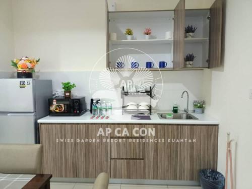 a kitchen with a refrigerator and a counter top at SG Resort Residences Kuantan by AP CA CON in Kampung Sungai Karang