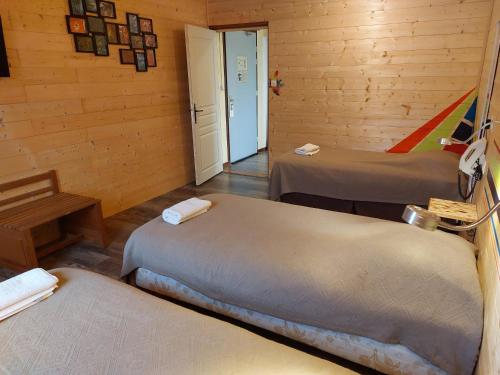 a room with two beds in a wooden cabin at Le Magiot in Montliot-et-Courcelles