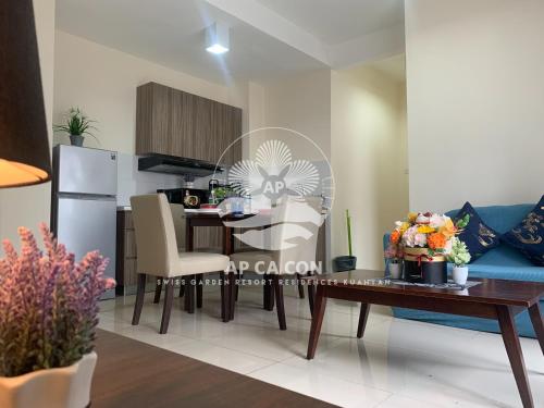 a kitchen and dining room with a table and chairs at SG Resort Residences Kuantan by AP CA CON in Kampung Sungai Karang