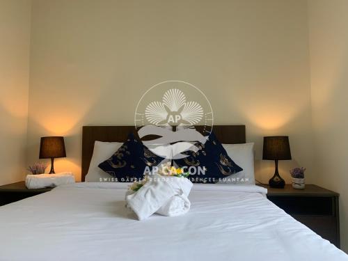 a bedroom with a bed with two towels on it at SG Resort Residences Kuantan by AP CA CON in Kampung Sungai Karang