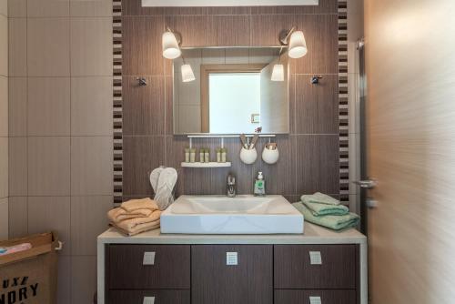 a bathroom with a sink and a mirror at Dreams Villa Luxury Residence in Sissi