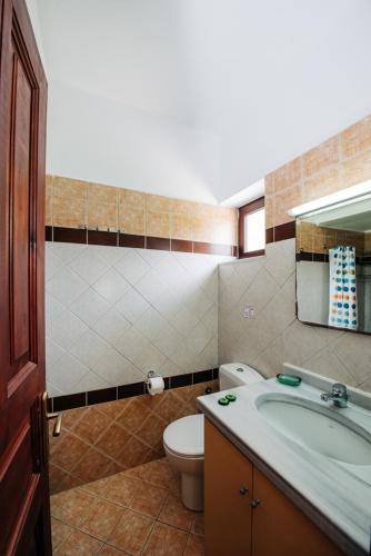 a bathroom with a tub and a toilet and a sink at Villagio in Lefkada
