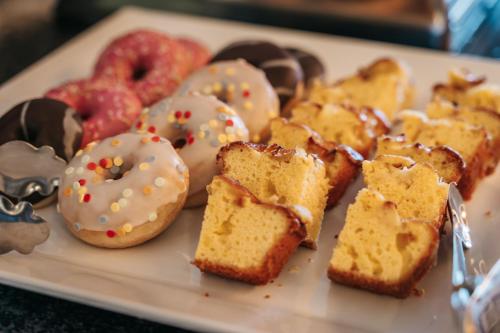 a plate of pastries and donuts on a table at Hotel Riant-Séjour by WP Hotels in Blankenberge