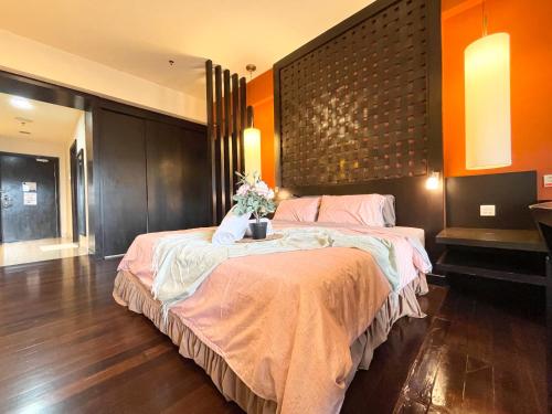 a bedroom with a large bed with flowers on it at Sunway Resort Suites max 4 pax studio 1 mins walk to Sunway Pyramid in Petaling Jaya