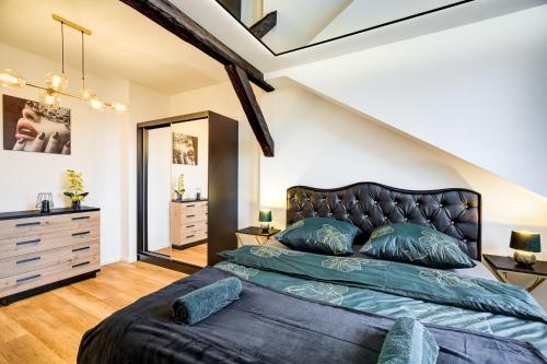 a bedroom with a king sized bed in a attic at Przy Deptaku in Nowy Sącz