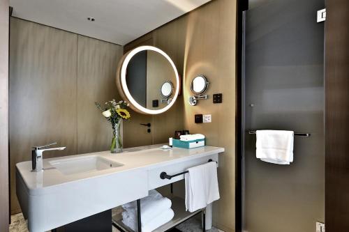 a bathroom with a sink and a mirror at Wyndham Garden Hangzhou Yuhang in Hangzhou