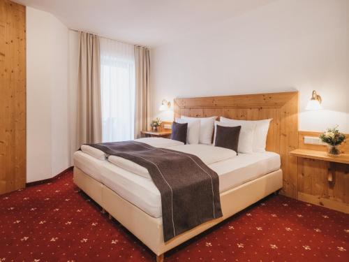 Кровать или кровати в номере Hotel Vier Jahreszeiten by VAYA