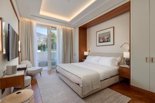 a hotel room with a bed and a balcony at Porto Montenegro Residences in Tivat