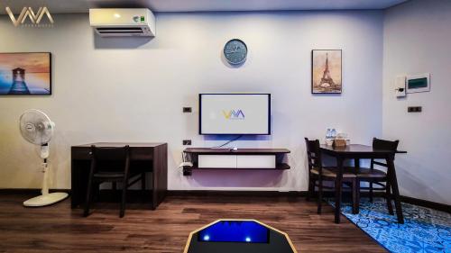 a room with a desk and a tv on a wall at VNAHOMES APARTHOTEL in Hanoi