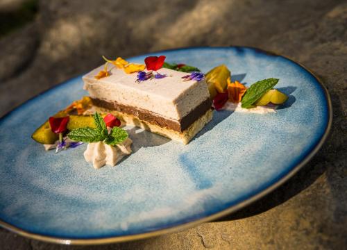 a piece of cake on a blue plate at Matild Country Hotel in Nemesvita
