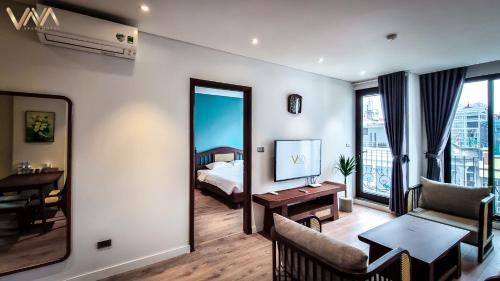 a hotel room with a bed and a living room at VNAHOMES APARTHOTEL in Hanoi