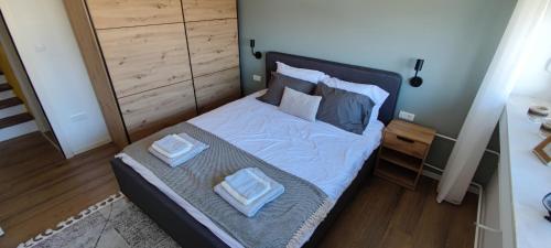 a bedroom with a bed with two pillows on it at Apartment 906 in Prishtina in Pristina