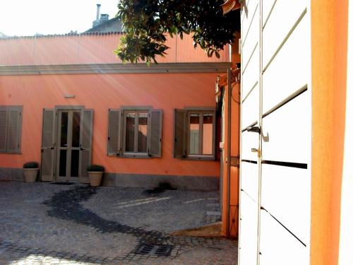 an outside view of an orange building with windows at Residenza il Nespolo - Estella Hotel Collection in Turin
