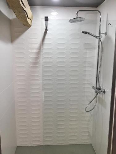 a bathroom with a shower with white walls at L'HIVERNET, grand Triplex neuf au cœur d'Embrun accès facile in Embrun