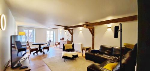 a living room with a couch and a table at L'HIVERNET, grand Triplex neuf au cœur d'Embrun accès facile in Embrun