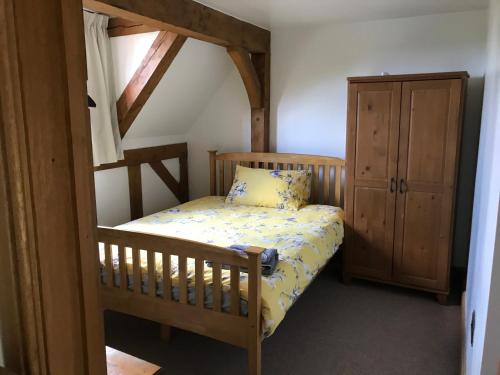 a small bedroom with a bunk bed and a cabinet at Cosy Cottage in the Countryside in Stafford