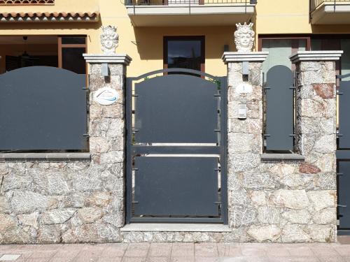 a door to a building with a stone wall at B&B Villa Chiara - Bed And Breakfast in Taormina