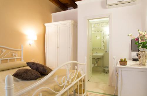 a bedroom with a white bed and a bathroom at B&B Monsignore in Vieste