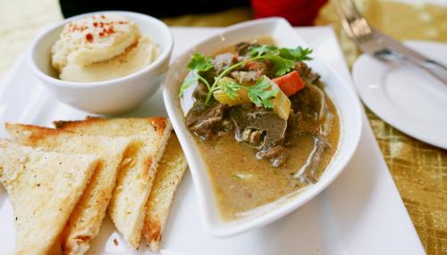 a plate of soup with bread and a bowl of ice cream at Shahzan Hotel Kuantan, Trademark Collection by Wyndham in Kuantan