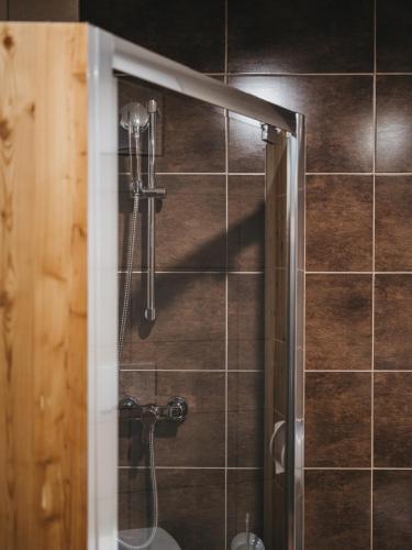 a shower with a glass door in a bathroom at Hotel Victoria by VAYA in Kaprun