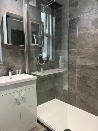 bagno con doccia e lavandino di Entire spacious 4 bedroom apartment in Bournemouth a Bournemouth