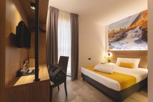 a hotel room with a bed and a desk at Hi Hotels Trento - Wellness & Spa Adults Only in Trento