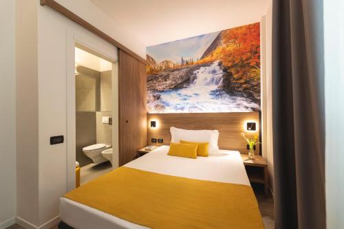 a hotel room with a bed and a painting on the wall at Hi Hotels Trento - Wellness & Spa Adults Only in Trento
