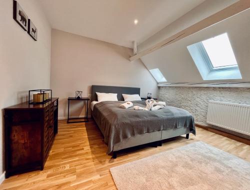 a bedroom with a bed with two dogs laying on it at Chalet & Apart Fichtelberger Blick in Kurort Oberwiesenthal