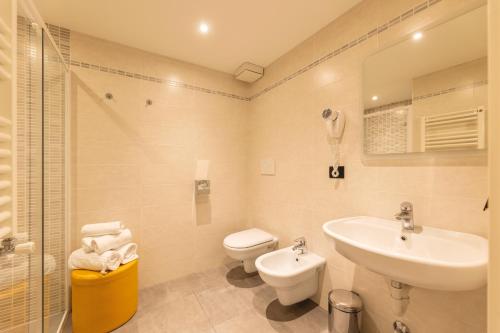 a bathroom with a sink and a toilet and a shower at Hi Hotels Trento - Wellness & Spa Adults Only in Trento