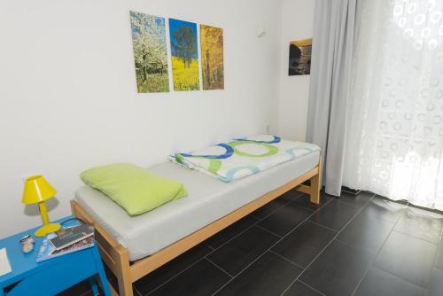 a small bed in a room with a table at schöner Meerblick von der Dachterrasse Haus Ostseeblick 1 FeWo Meehrblick in Lohme