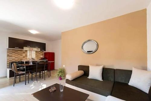 a living room with a couch and a table at Elisabeth Luxury Villas in Vourvourou
