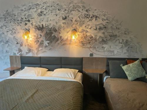 a bedroom with a bed with lights on the wall at Villa Hotel in Troyes