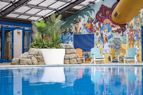 a swimming pool with a mural on the wall at Marine Holiday Park in Rhyl