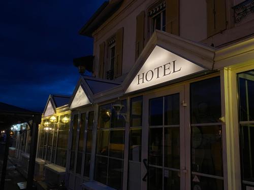 a hotel sign on the side of a building at night at Hotel de la Gare in Saint-Mihiel